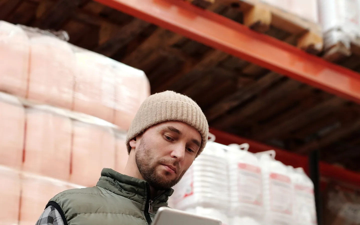 A warehouse colleague checking an inventory record.