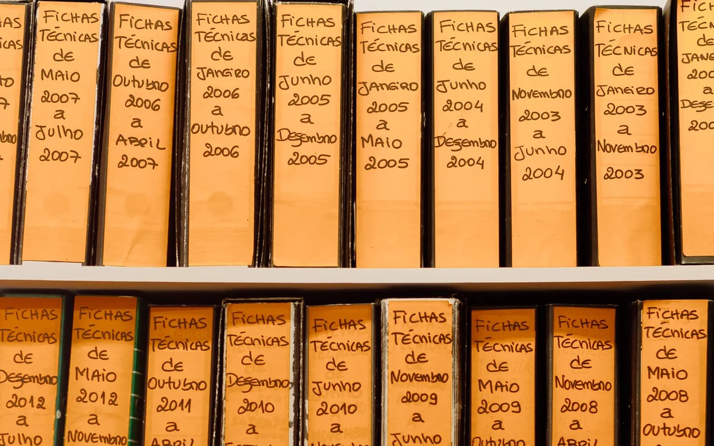 Labelled office files arranged on shelves.
